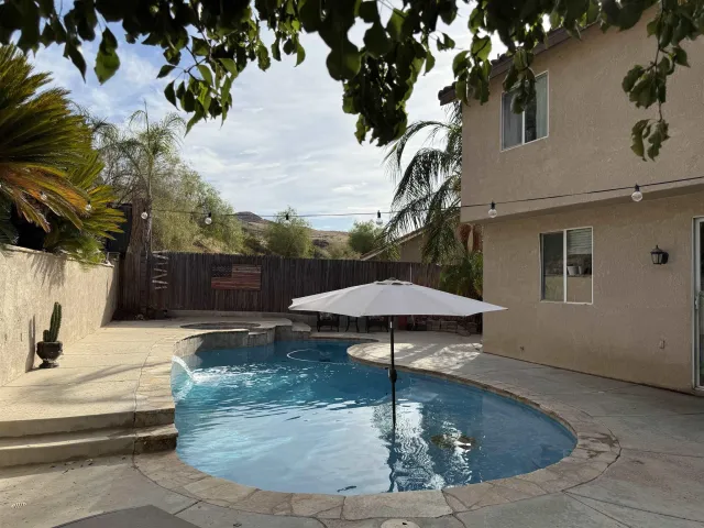 a view of a house with backyard and sitting area