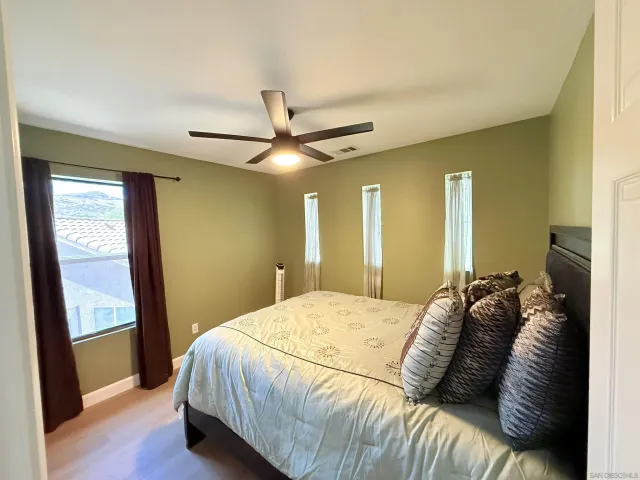 a bedroom with a bed and a large mirror