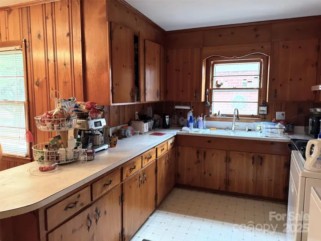 a kitchen with large windows and sink