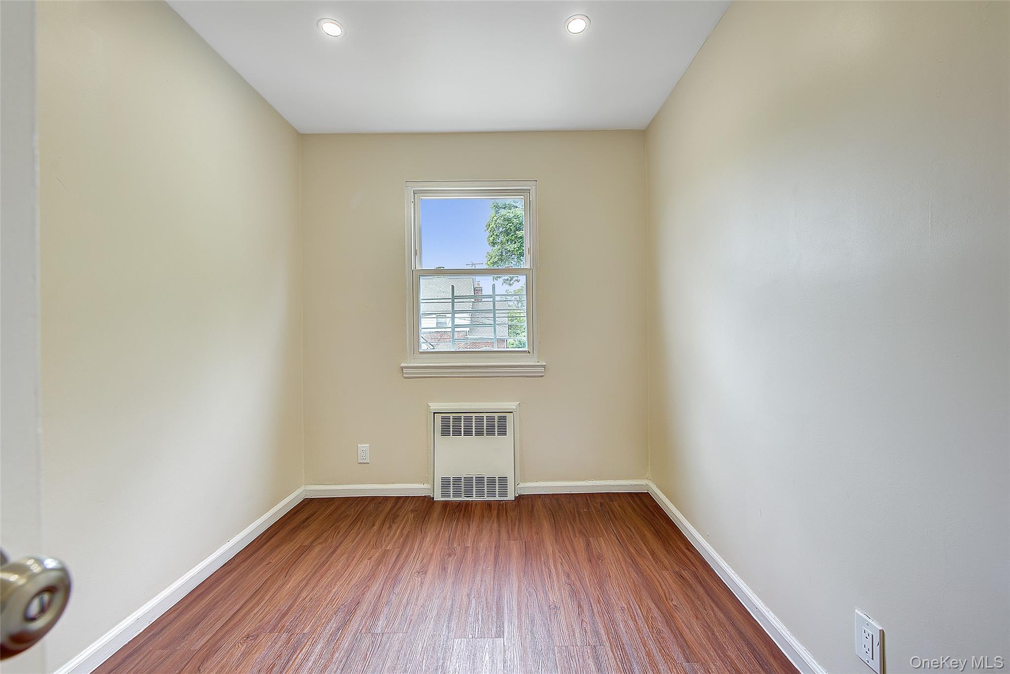 164-38 76th Road Queens, NY 11366 - Photo 21 of 44 a view of room with window and wooden floor