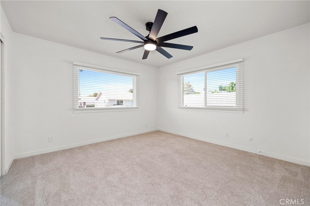 483 South Pine Street Orange, CA 92866 - Photo 12 of 14 an empty room with wooden floor ceiling fan and windows