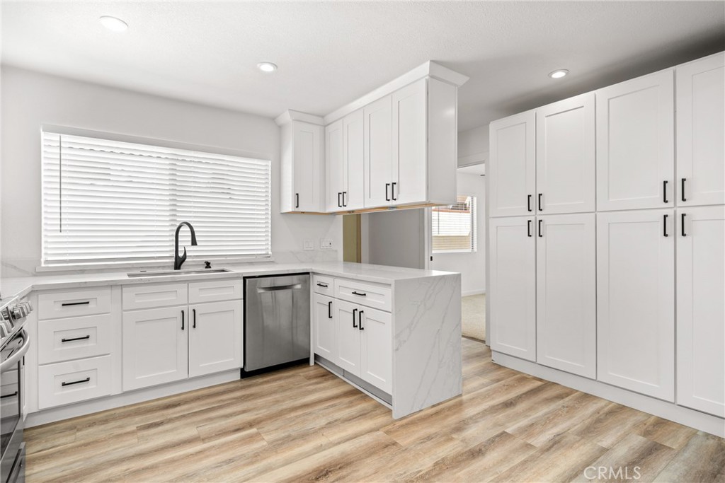 483 South Pine Street Orange, CA 92866 - Photo 4 of 14 a kitchen with white cabinets and white appliances