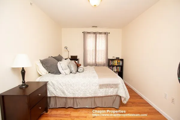 a bedroom with a bed and window