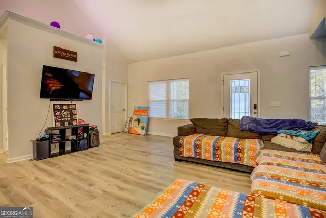 a living room with furniture and a flat screen tv