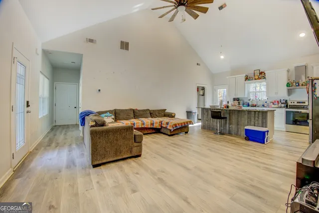 a living room with furniture and kitchen view