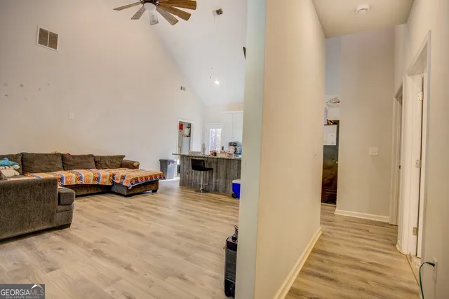 a living room with furniture and a wooden floor