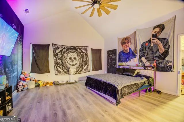 a spacious bedroom with a bed and a table in it