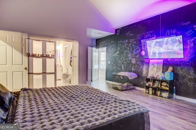 a bedroom with a bed and wooden floor