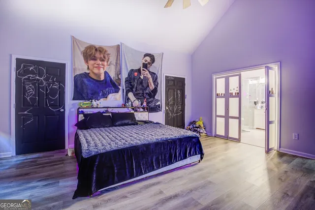 a bedroom with a bed and wooden floor