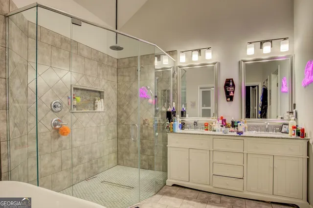 a bathroom with a double vanity sink mirror and shower