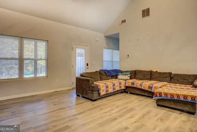 a spacious bedroom with a bed and a couch