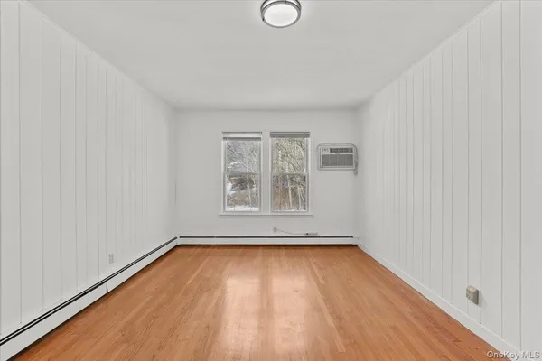 a view of a room with wooden floor and window