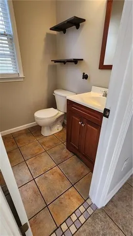 a bathroom with a sink a toilet and mirror