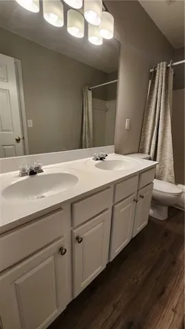 a view of a room with wooden floor