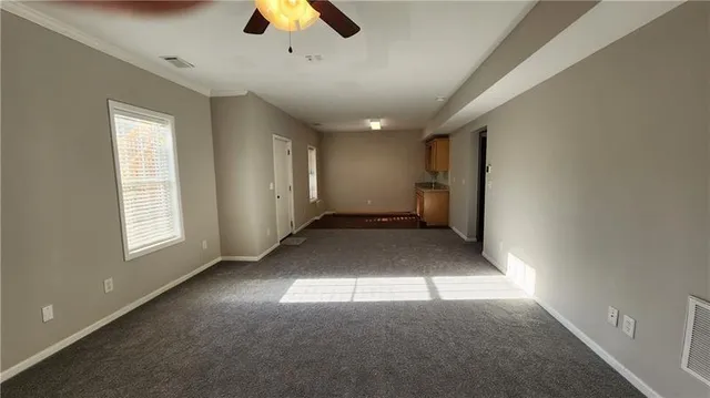 a view of a kitchen with wooden floor and cabinets