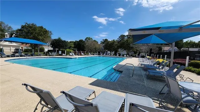 a view of a house with backyard and sitting area