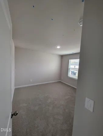 a view of an empty room and a window