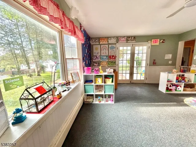 a living room with furniture and a floor to ceiling window