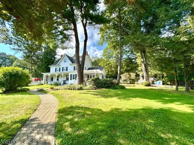 a front view of a house with yard and green space