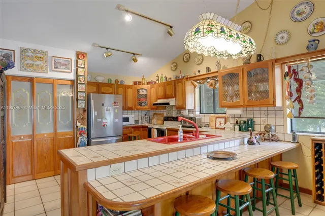 a kitchen with a table chairs and a chandelier