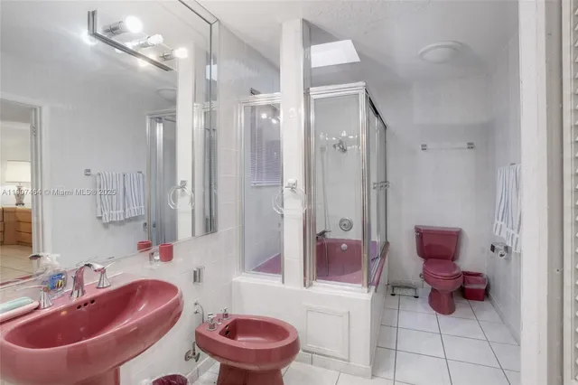 a bathroom with a sink toilet tub and shower
