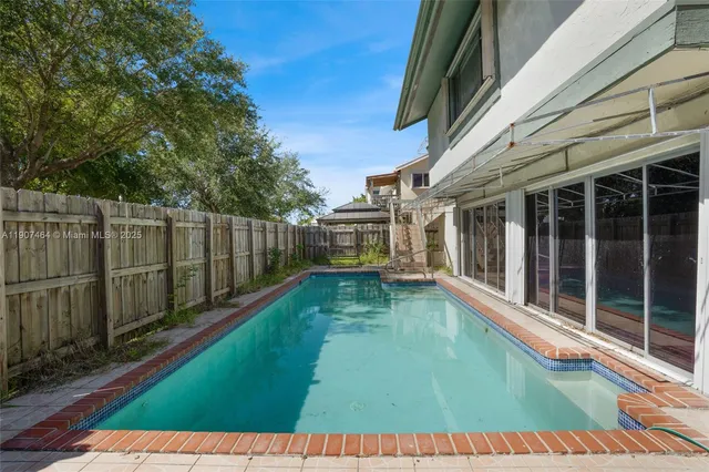a view of a house with backyard porch and sitting area
