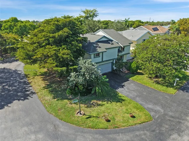 an aerial view of a house with a yard