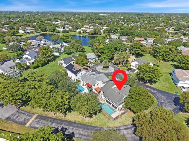 an aerial view of residential houses with yard