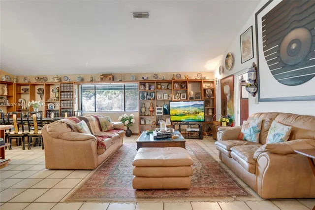 a living room with furniture and a floor to ceiling window