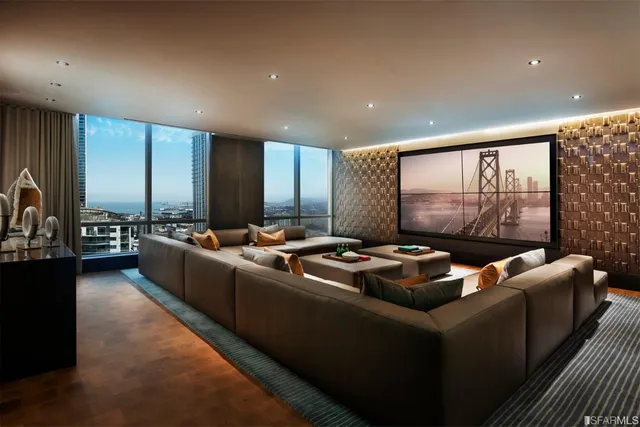 a living room with furniture city view and large windows