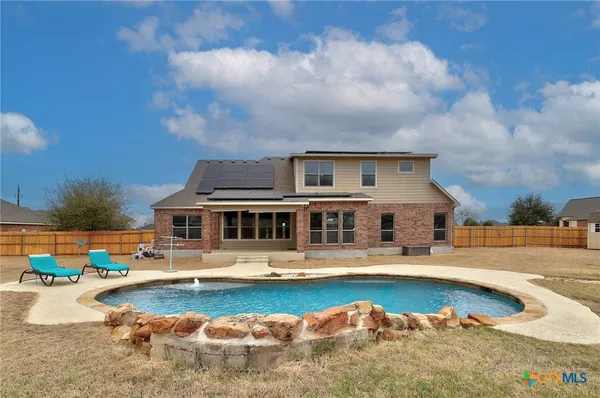 a view of a swimming pool with a yard