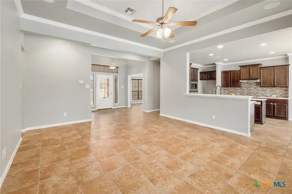 a view of an empty room with a kitchen