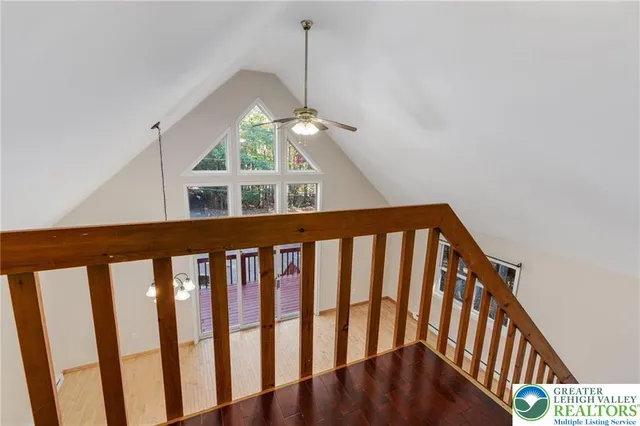 a view of staircase with railing and a window