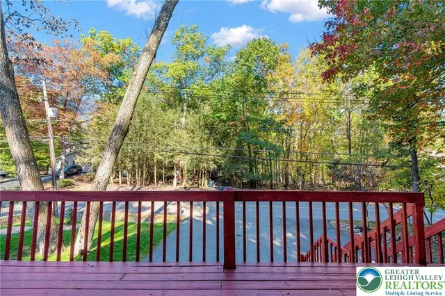 a balcony with wooden floor and fence