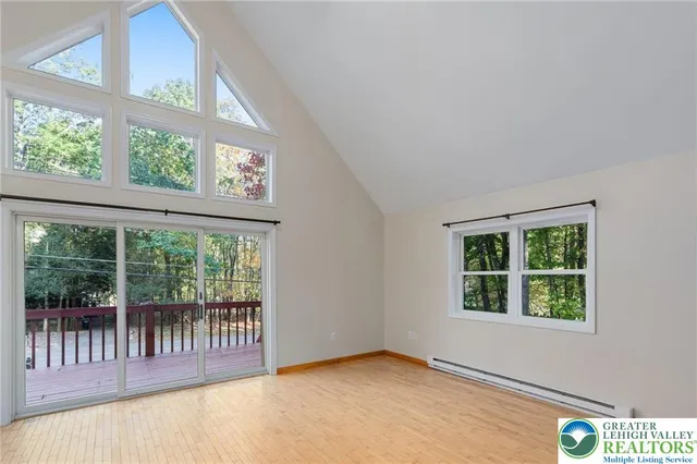 an empty room with large windows