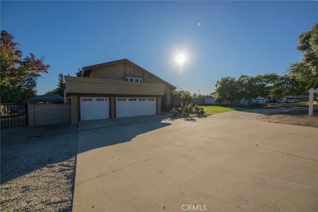 a view of a house with a yard and sitting area