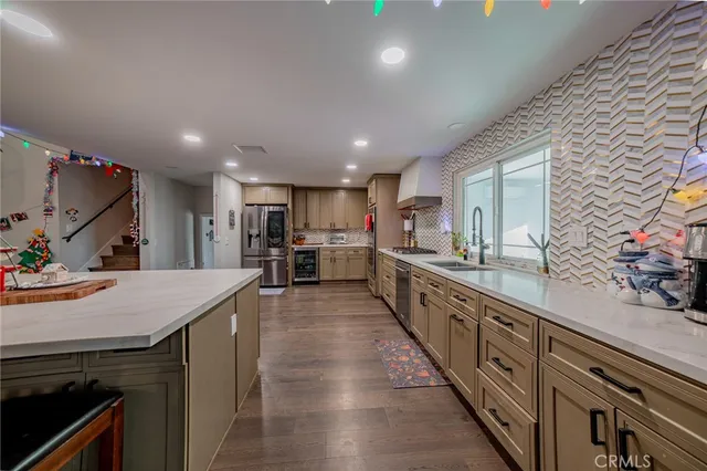 a large kitchen with stainless steel appliances lots of counter space and a sink