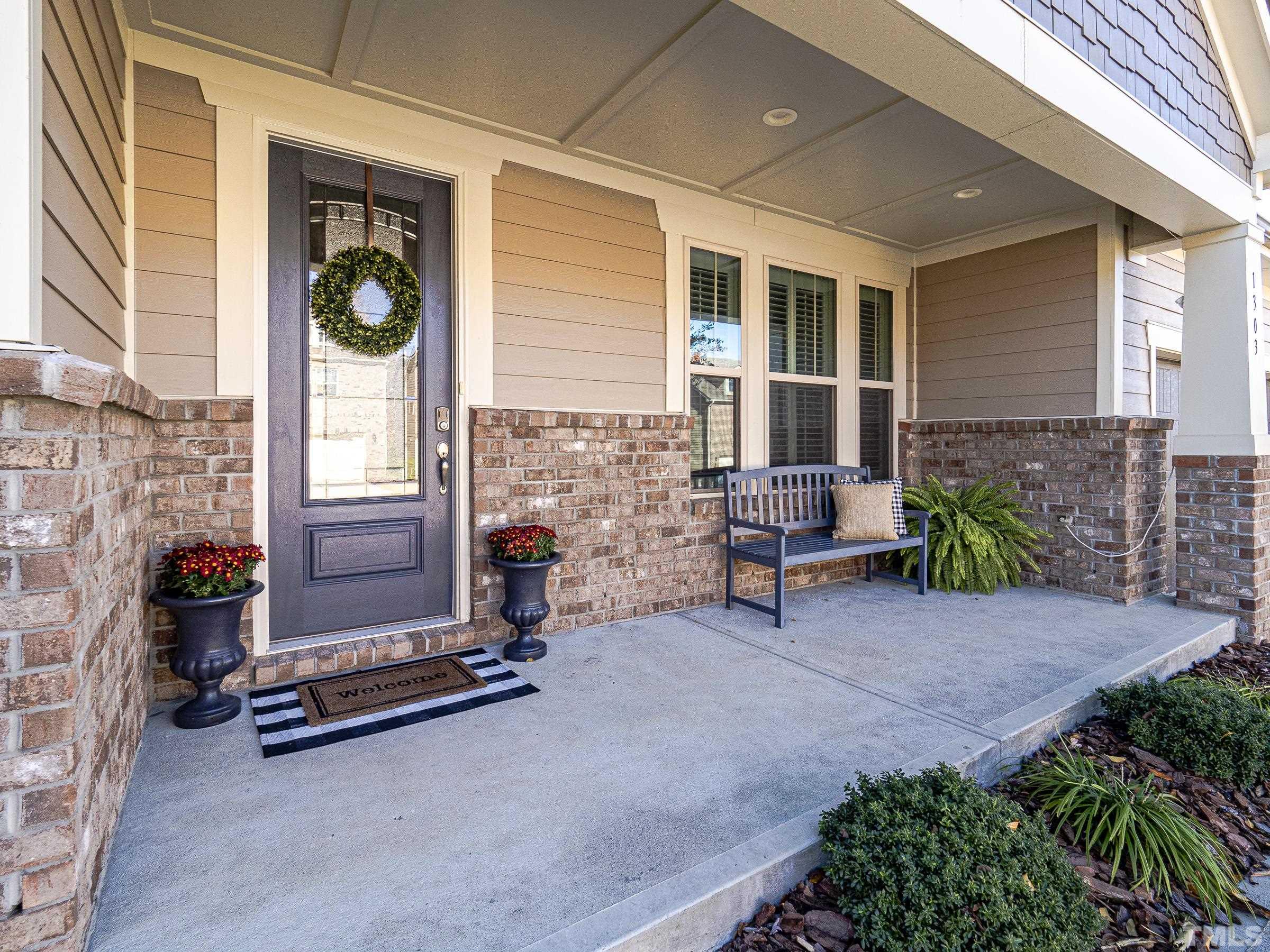 1303 Capstone Drive Durham, NC 27713 - Photo 2 of 27 a view of a patio with couple of chairs and a table