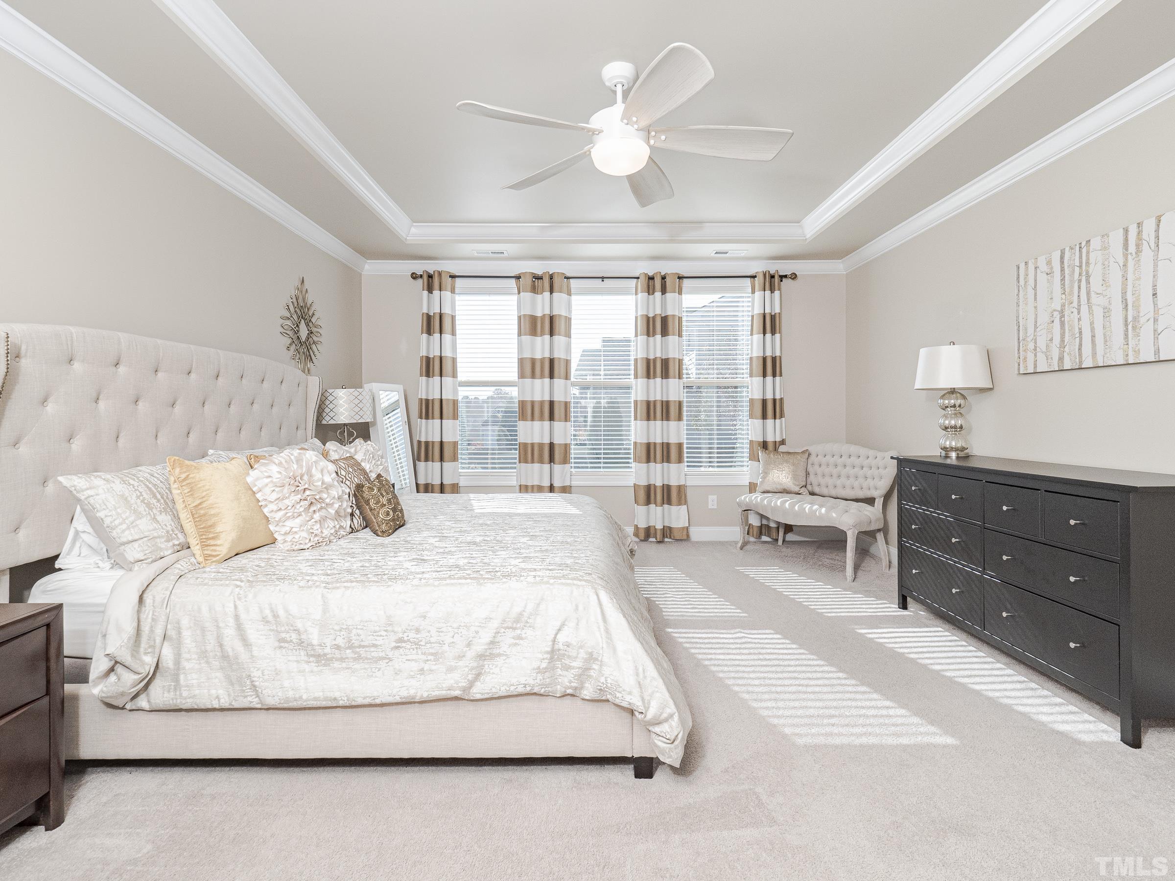 1303 Capstone Drive Durham, NC 27713 - Photo 19 of 27 a spacious bedroom with a large bed and a chandelier