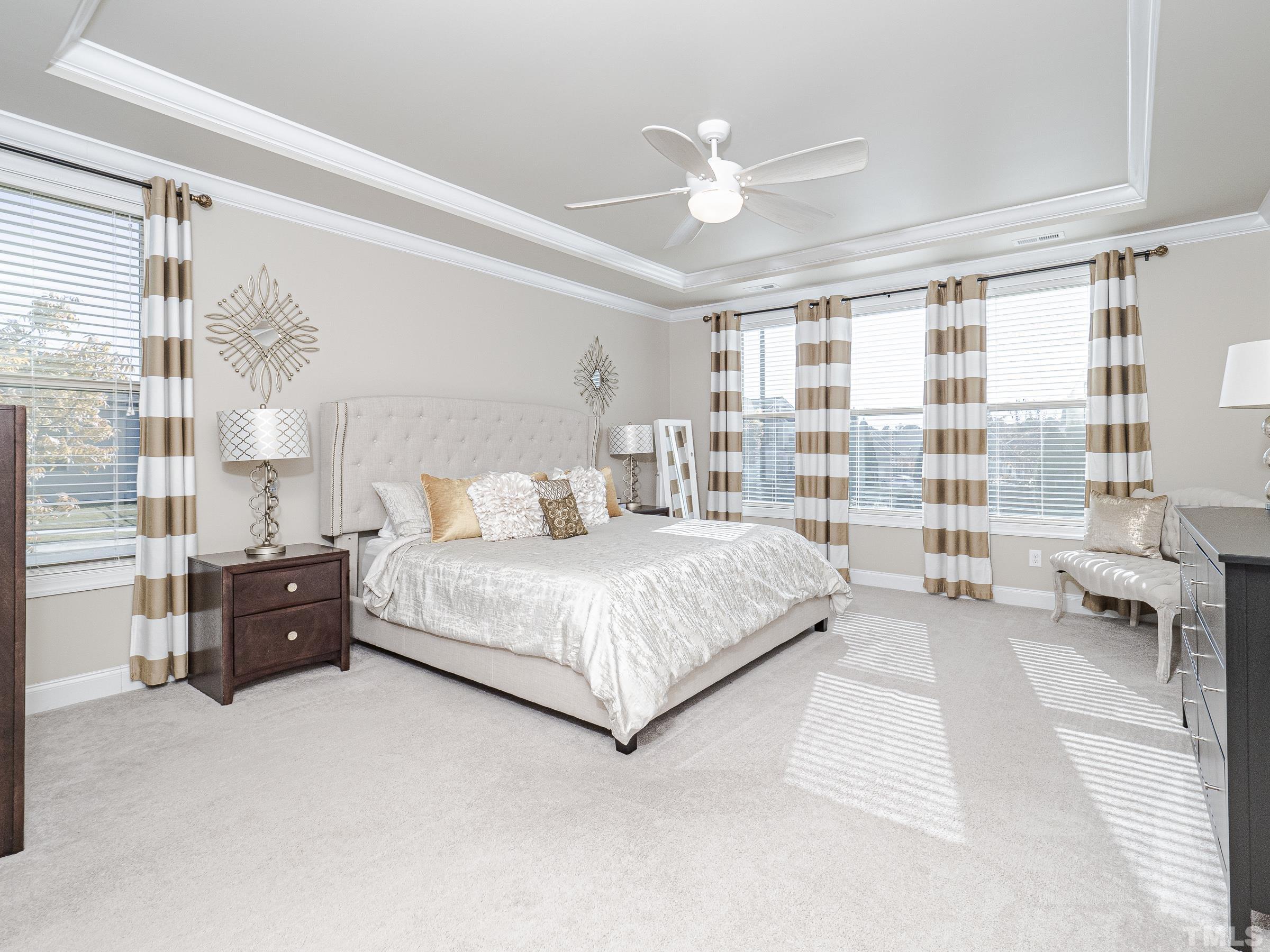 1303 Capstone Drive Durham, NC 27713 - Photo 20 of 27 a bedroom with a large bed and a chandelier