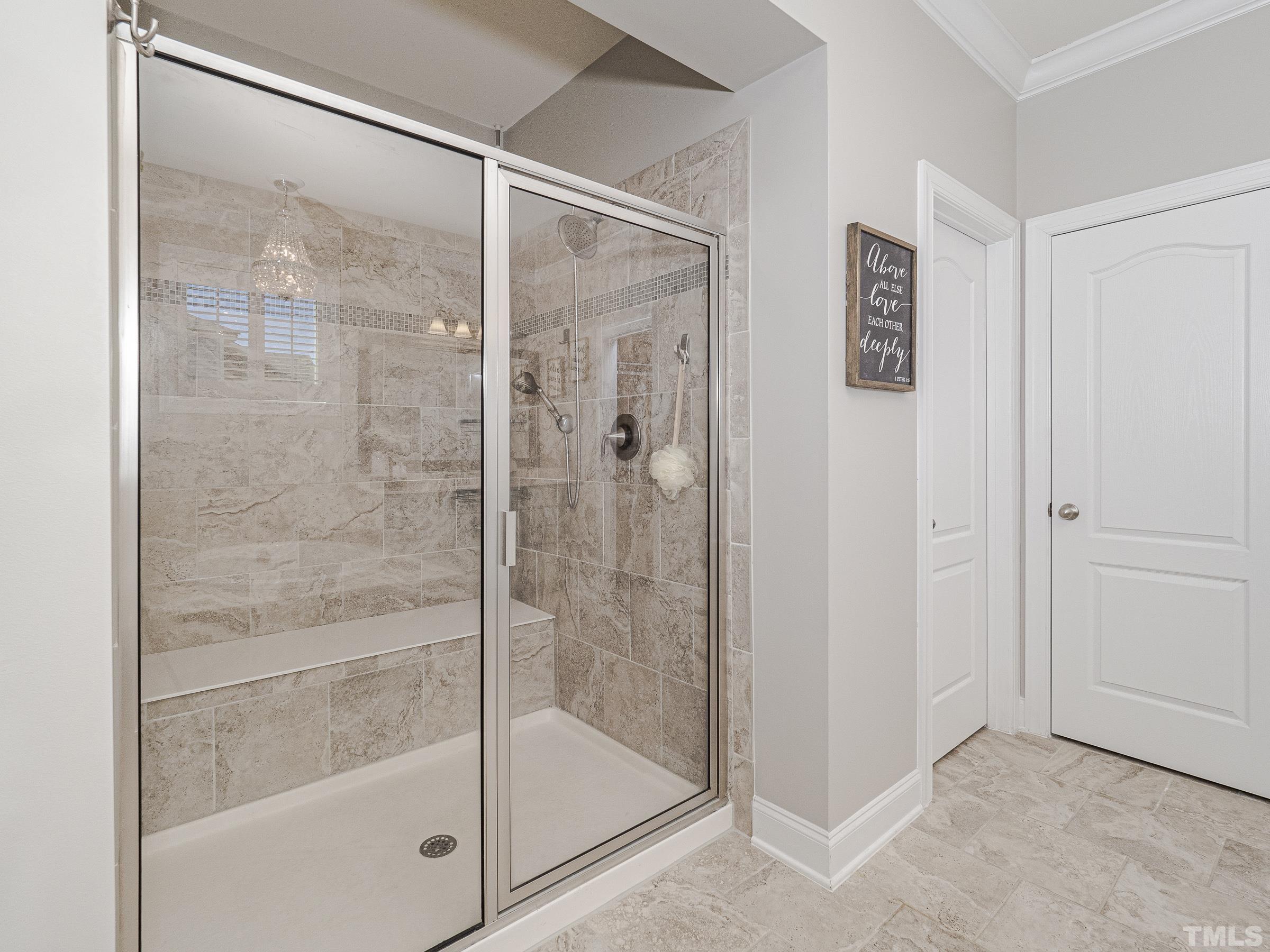 1303 Capstone Drive Durham, NC 27713 - Photo 22 of 27 a bathroom with a glass shower door