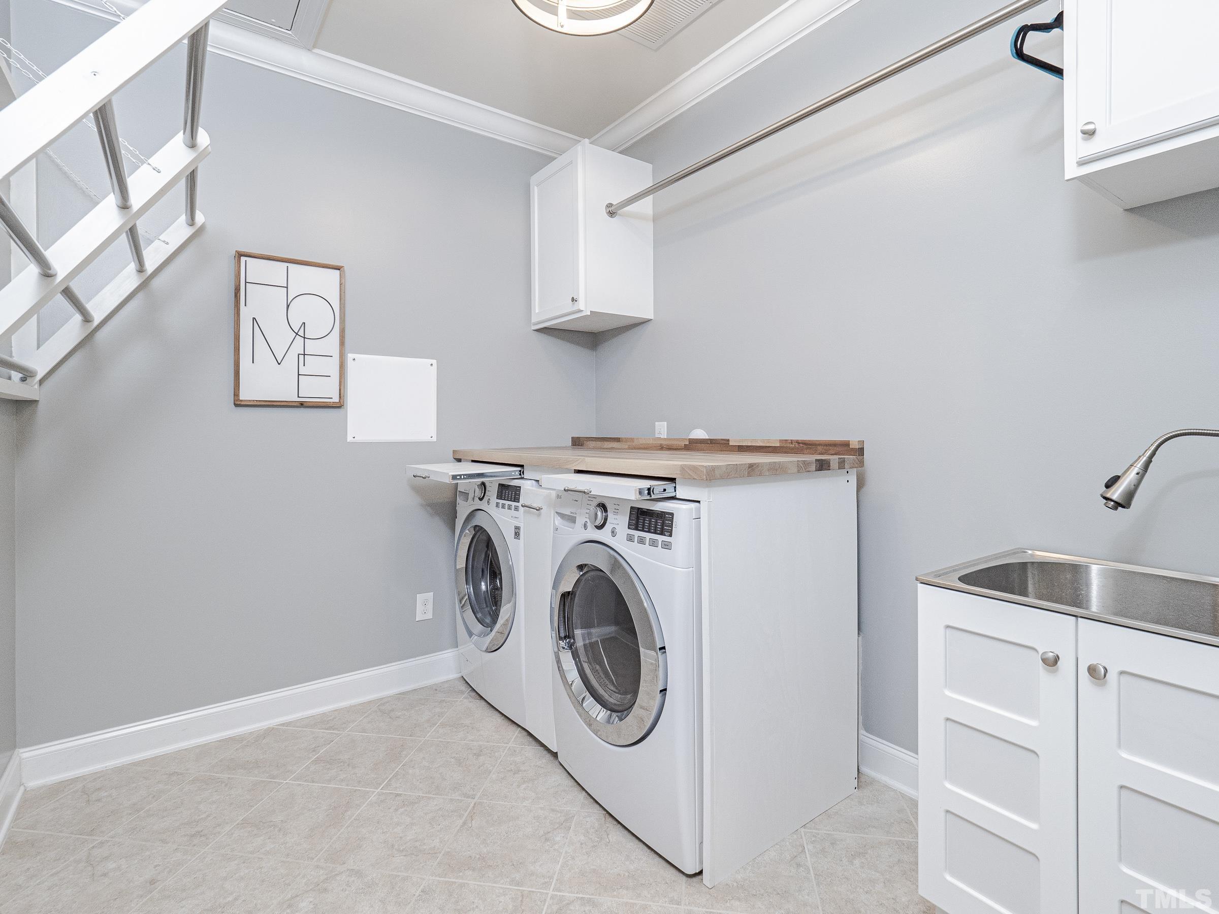1303 Capstone Drive Durham, NC 27713 - Photo 5 of 27 a utility room with sink dryer and washer