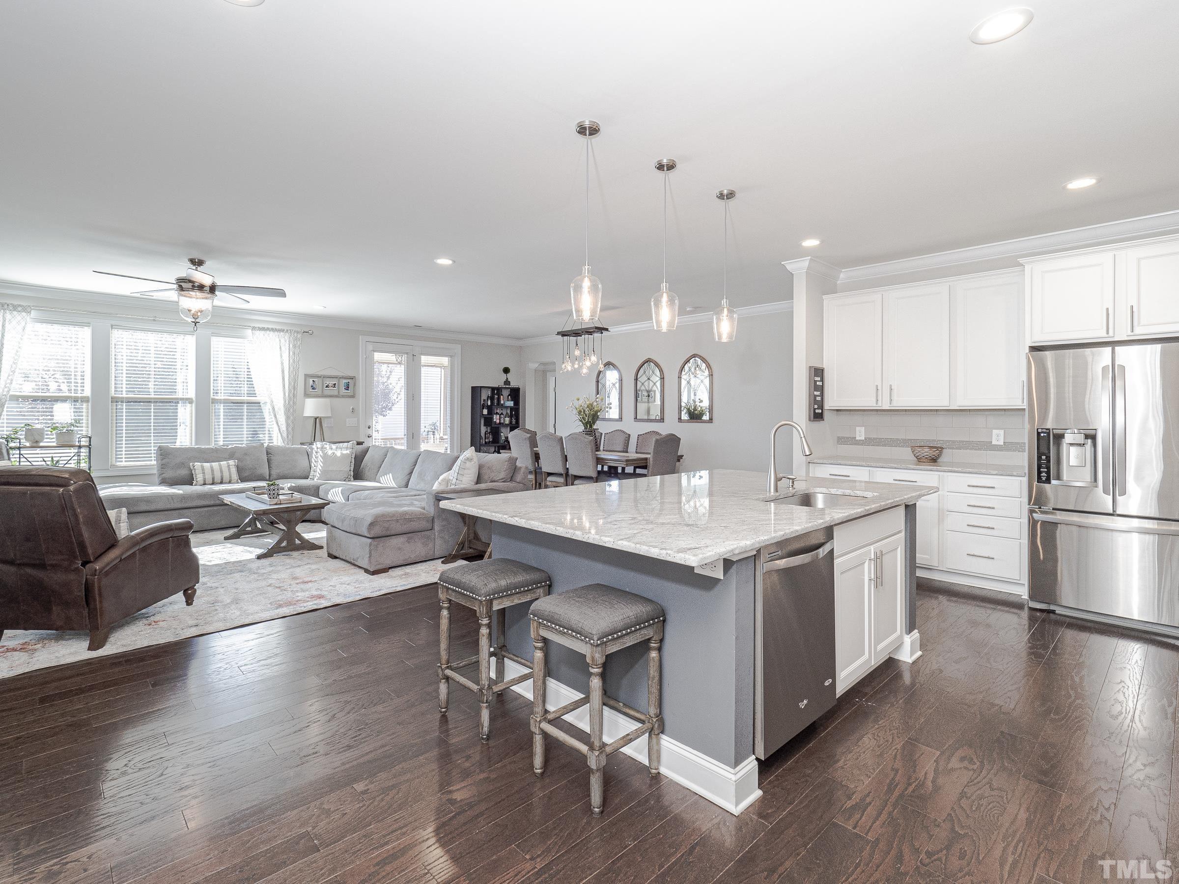 1303 Capstone Drive Durham, NC 27713 - Photo 7 of 27 a kitchen with stainless steel appliances granite countertop a lot of counter space and wooden floors