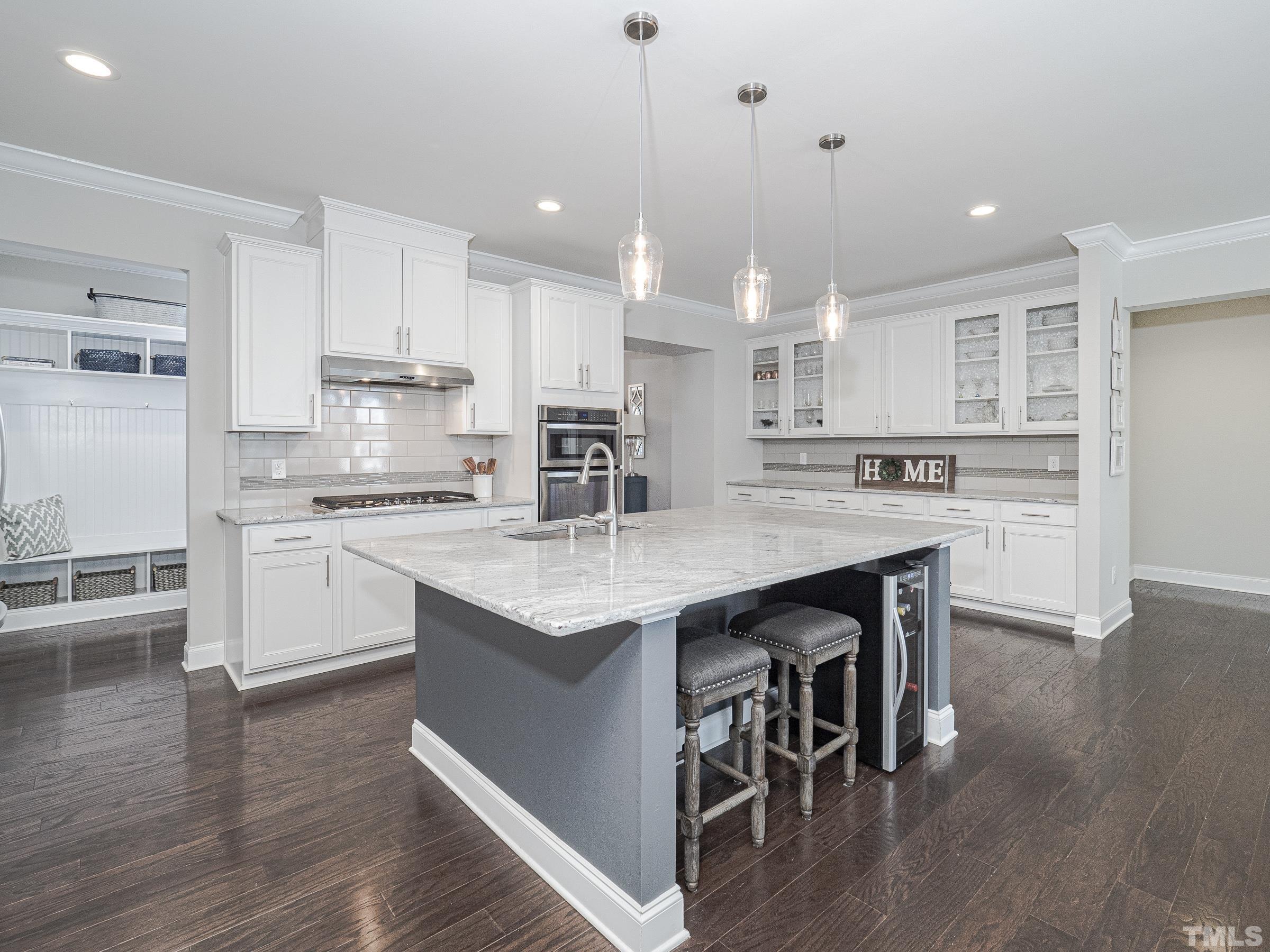 1303 Capstone Drive Durham, NC 27713 - Photo 8 of 27 a kitchen with stainless steel appliances granite countertop a stove top oven a sink dishwasher and a refrigerator with wooden floor