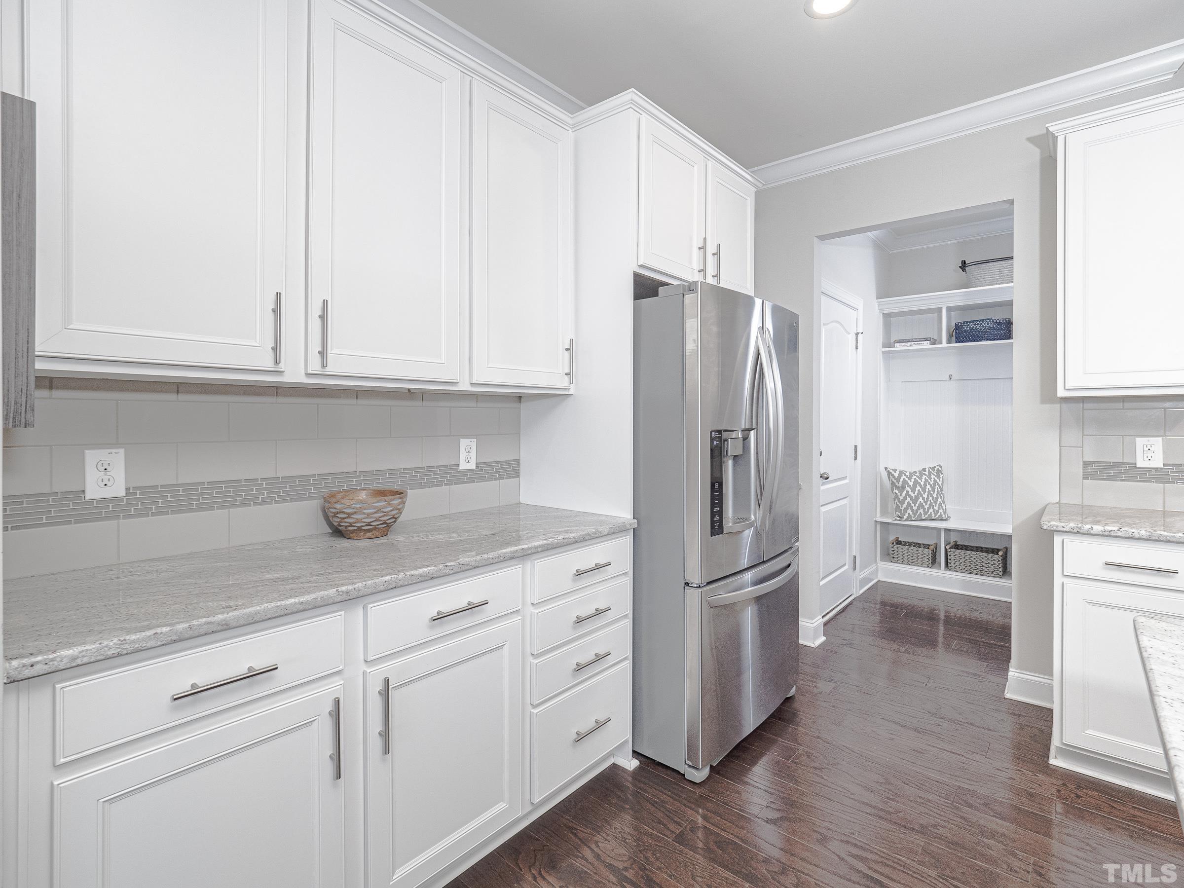 1303 Capstone Drive Durham, NC 27713 - Photo 9 of 27 a kitchen with stainless steel appliances white cabinets and a refrigerator