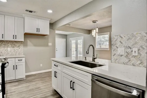 a kitchen with sink a microwave and stove