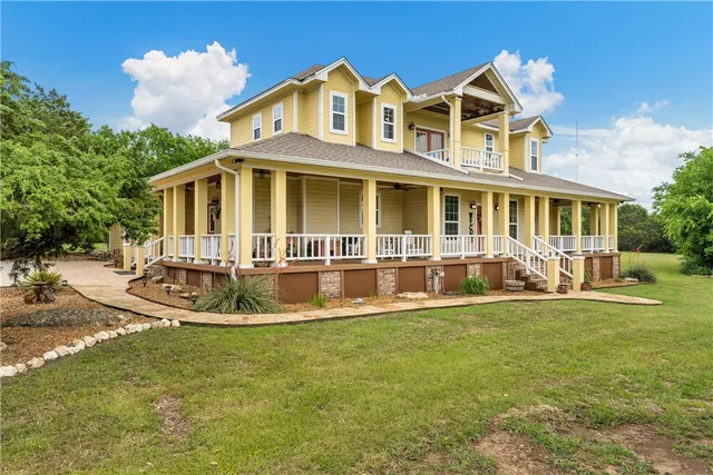 a front view of a house with a yard table and chairs