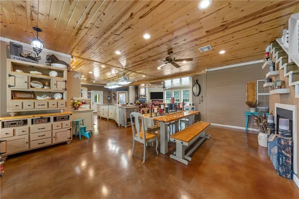 a room with lots of wooden furniture and a chandelier