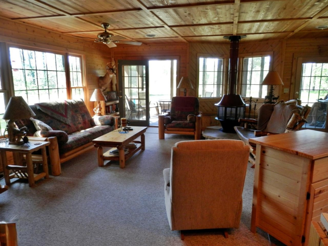 841 11 Mile Road Irons, MI 49644 - Photo 12 of 38 Living room looking to screened porch