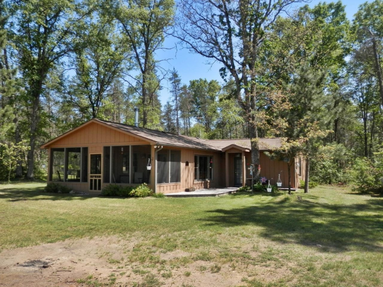 841 11 Mile Road Irons, MI 49644 - Photo 2 of 38 Tall oaks and pine provide privacy